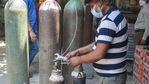 A worker refills oxygen cylinders for Covid-19 patients at a oxygen filling centre, in New Delhi on Sunday.(PTI Photo) A worker refills oxygen cylinders for Covid-19 patients at a oxygen filling centre, in New Delhi on Sunday.(PTI Photo)