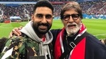 Abhishek Bachchan and Amitabh Bachchan pose together at a football match.