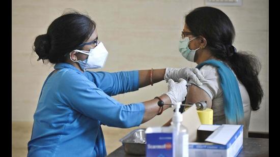 A woman receives a dose of Covid-19 vaccine in Gurugram on Sunday. (Parveen Kumar/HT) A woman receives a dose of Covid-19 vaccine in Gurugram on Sunday. (Parveen Kumar/HT)
