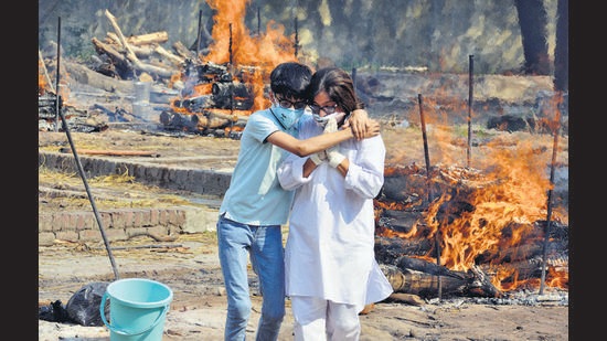 Family members of a Covid victim at the Sector 28 cremation ground in Panchkula on Sunday. (Sant Arora/HT) Family members of a Covid victim at the Sector 28 cremation ground in Panchkula on Sunday. (Sant Arora/HT)