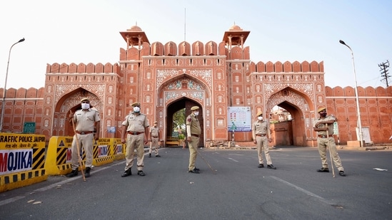 Police personnel stand guard outside the historic Sanganeri Gate after announcement of a lockdown, in Jaipur, Sunday, May 9, 2021. (PTI) Police personnel stand guard outside the historic Sanganeri Gate after announcement of a lockdown, in Jaipur, Sunday, May 9, 2021. (PTI)