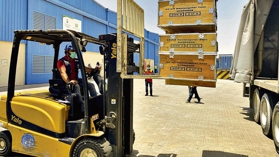A driver loads the medical supplies, which will be sent to India, at the International Humanitarian City in Dubai on Sunday.(Reuters) A driver loads the medical supplies, which will be sent to India, at the International Humanitarian City in Dubai on Sunday.(Reuters)