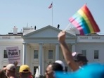 Equality March for Unity and Pride participants march past the White House in Washington.