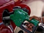 A worker holds a nozzle to pump petrol into a vehicle at a fuel station in Mumbai, India. A worker holds a nozzle to pump petrol into a vehicle at a fuel station in Mumbai, India.
