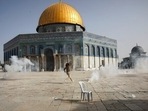 Palestinian man runs away from tear gas during clashes with Israeli security forces in the Al Aqsa Mosque compound in Jerusalem's Old City.(AP) Palestinian man runs away from tear gas during clashes with Israeli security forces in the Al Aqsa Mosque compound in Jerusalem's Old City.(AP)