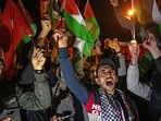 Protesters hold Palestine and Turkish national flags and chant slogans during a demonstration against Israel in front of the Israeli Consulate in Istanbul.(AFP) Protesters hold Palestine and Turkish national flags and chant slogans during a demonstration against Israel in front of the Israeli Consulate in Istanbul.(AFP)
