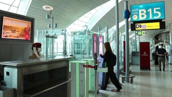 A woman enters the face and iris-recognition gate to board a plane, during a media tour at Dubai Airport, in the UAE. (AP / File)