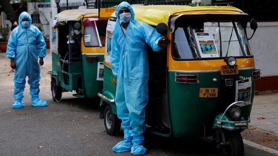 Autorickshaw ambulance drivers in PPE coveralls wait for Covid-19 patients and attendants, in New Delhi on May 5. The CM said Delhi “cannot to afford” to let its “guard down” even though the number of cases and the test-positivity rate -- an indication of the spread of an outbreak within an area -- has seen a declining trend over the last few days.(Adnan Abidi / REUTERS)