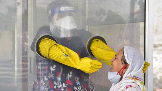 A health worker collecting swab samples for Covid testing at the community health centre in Jawaddi in Ludhiana on Monday. (Gurpreet Singh/HT) A health worker collecting swab samples for Covid testing at the community health centre in Jawaddi in Ludhiana on Monday. (Gurpreet Singh/HT)