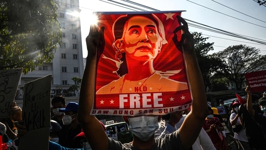 A protester holds up a poster featuring Aung San Suu Kyi during a demonstration against the military coup at in front of the Central Bank of Myanmar in Yangon.(AFP)