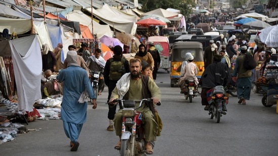 People make their way along a market area in Kandahar.(AFP) People make their way along a market area in Kandahar.(AFP)