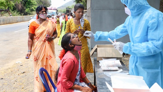 A medic takes swab samples for Covid-19 test. (PTI) A medic takes swab samples for Covid-19 test. (PTI)