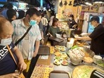 People wear face masks to protect against the spread of the coronavirus and visit at a night market in Taipei, Taiwan. People wear face masks to protect against the spread of the coronavirus and visit at a night market in Taipei, Taiwan.