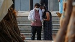 A couple mourns as they stand next to the funeral pyre of a relative who died due to coronavirus disease (Covid-19), at a crematorium in New Delhi on Monday. (Adnan Abidi / REUTERS)