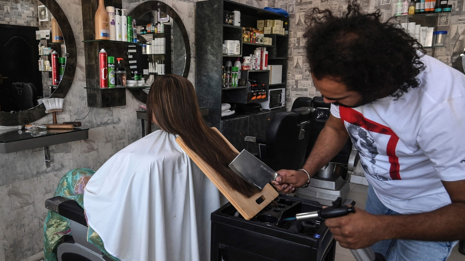 With cleavers and blowtorches, Pakistan barber offers hairraising cuts