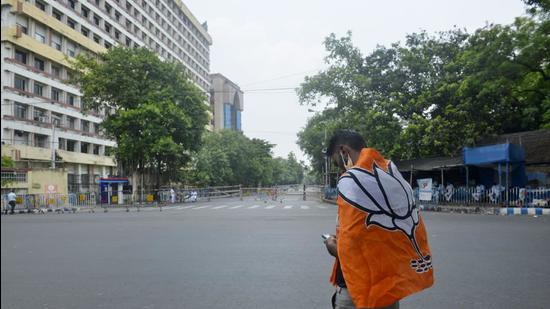 West Bengal, May 02 (ANI): BJP supporter wears the party flag during the election result day of the West Bengal Assembly election, in Kolkata on Sunday. (ANI Photo) (ANI) West Bengal, May 02 (ANI): BJP supporter wears the party flag during the election result day of the West Bengal Assembly election, in Kolkata on Sunday. (ANI Photo) (ANI)