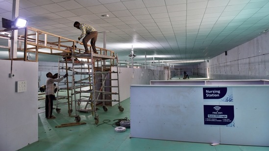 Workers setting up a 500-bed Covid-19 Care Centre at Ramlila Maidan in front of LNJP hospital, in New Delhi on May 11. Elaborating the government’s infrastructure augmentation plan, senior officials told HT it includes increasing beds in hospitals as well as creating more centres in open grounds, sites run by religious organisations and stadiums.(Ajay Aggarwal / HT Photo)