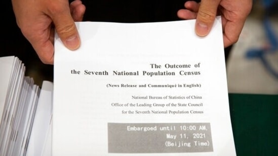 A staff member waits to hand out a copy of a news release outlining the results of China's latest population census before a press conference at the State Council Information Office in Beijing, Tuesday, May 11, 2021. China's population growth is falling closer to zero as fewer couples have children, the government announced Tuesday, adding to strains on an aging society with a shrinking workforce. (AP) A staff member waits to hand out a copy of a news release outlining the results of China's latest population census before a press conference at the State Council Information Office in Beijing, Tuesday, May 11, 2021. China's population growth is falling closer to zero as fewer couples have children, the government announced Tuesday, adding to strains on an aging society with a shrinking workforce. (AP)
