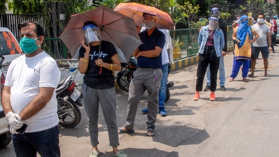 People wait in a long queue to receive COVID-19 vaccine doses, (PTI) People wait in a long queue to receive COVID-19 vaccine doses, (PTI)