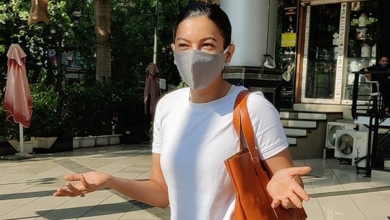 Gauahar Khan smiles from under her mask for the cameras.