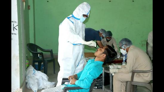 A health worker collecting a sample for the Covid-19 test after testing was ramped up at Titoli village near Rohtak last week. (Manoj Dhaka/HT) A health worker collecting a sample for the Covid-19 test after testing was ramped up at Titoli village near Rohtak last week. (Manoj Dhaka/HT)