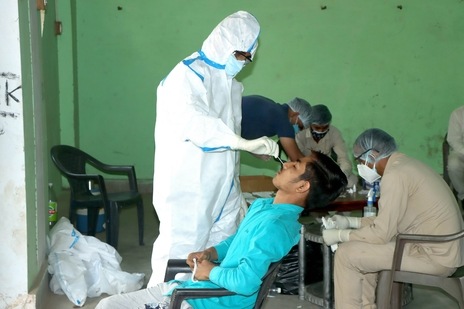 A frontline worker tests a sample from a patient showing symptoms of the coronavirus disease (Covid-19) in Haryana, India. The state is offering <span class='webrupee'>₹</span>5,000 to each family below poverty line as relief amid this pandemic. (File Photo / Representational Image)