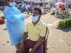 A health worker collects a swab sample for the Covid-19 test at a market in Jammu. A health worker collects a swab sample for the Covid-19 test at a market in Jammu.