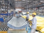 Employees guide finished corrugated steel roofing onto a pallet in the tube mill at the manufacturing facility of Uttam Galva Steels Ltd., the Indian unit of ArcelorMittal, in Khopoli, Maharashtra, India. Employees guide finished corrugated steel roofing onto a pallet in the tube mill at the manufacturing facility of Uttam Galva Steels Ltd., the Indian unit of ArcelorMittal, in Khopoli, Maharashtra, India.