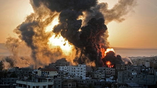 A fire rages at sunrise in Khan Yunish following an Israeli airstrike on targets in the southern Gaza strip, Palestine on May 12. Israel carried out hundreds of air strikes in Gaza into the morning on May 12 as the Islamist group Hamas and other Palestinian militants fired multiple rocket barrages over the border at Tel Aviv and the southern city of Beersheba, Reuters reported.(Youssef Massoud / AFP)