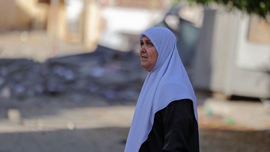 A Palestinian woman looks at heavily-damaged buildings in Gaza City on May 12. At least 43 people have been killed in Gaza, two Palestinians in the West Bank and five in Israel in the most intense exchanges for years, AFP reported.(Mohammed Abed / AFP)