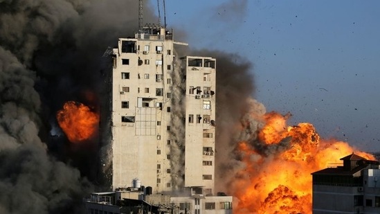 Smoke and flames rise from a tower building as it is destroyed by Israeli air strikes amid a flare-up of Israeli-Palestinian violence, in Gaza City. (REUTERS)