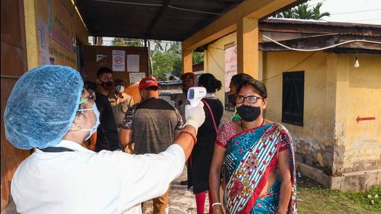 Voters being screened for Covid-19 symptoms at a polling booth for Assam assembly elections, in Guwahati on April 6. (File photo) Voters being screened for Covid-19 symptoms at a polling booth for Assam assembly elections, in Guwahati on April 6. (File photo)