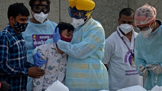 A man mourns as he with volunteers prepare to perform the last rites of a child who died of Covid-19 coronavirus at a crematorium in New Delhi. (AFP) A man mourns as he with volunteers prepare to perform the last rites of a child who died of Covid-19 coronavirus at a crematorium in New Delhi. (AFP)