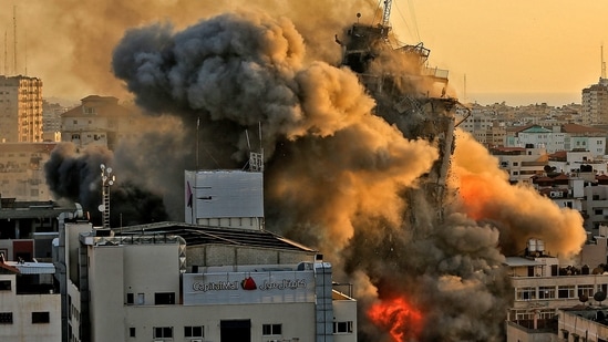 Heavy smoke and fire rise from Al-Sharouk tower as it collapses after being hit by an Israeli air strike, in Gaza City. (AFP) Heavy smoke and fire rise from Al-Sharouk tower as it collapses after being hit by an Israeli air strike, in Gaza City. (AFP)