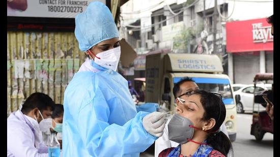 A health worker collecting swab sample at Chaura Bazaar in Ludhiana on Wednesday. (Gurpreet Singh/HT) A health worker collecting swab sample at Chaura Bazaar in Ludhiana on Wednesday. (Gurpreet Singh/HT)