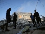Palestinian men stand amidst debris near the al-Sharouk tower, which housed the bureau of the Al-Aqsa television channel in the Hamas-controlled Gaza Strip, after it was destroyed by an Israeli airstrike, in Gaza City, on May 13, 2021. Palestinian men stand amidst debris near the al-Sharouk tower, which housed the bureau of the Al-Aqsa television channel in the Hamas-controlled Gaza Strip, after it was destroyed by an Israeli airstrike, in Gaza City, on May 13, 2021.