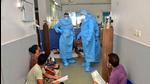 Goa chief minister Pramod Sawant (L), wearing a personal protective equipment suit, speaks to Covid-19 patients on May 11 at the Goa Medical College and Hospital, in Panaji after 26 people died in the hospital. (File photo) Goa chief minister Pramod Sawant (L), wearing a personal protective equipment suit, speaks to Covid-19 patients on May 11 at the Goa Medical College and Hospital, in Panaji after 26 people died in the hospital. (File photo)