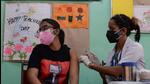 A health worker inoculates a young woman with a dose of Covishield vaccine at a school used as a vaccination centre in New Delhi on May 11. (AFP) A health worker inoculates a young woman with a dose of Covishield vaccine at a school used as a vaccination centre in New Delhi on May 11. (AFP)