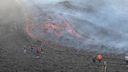 People watch as lava flows from Guatemala's Pacaya Volcano at the Cerro Chino hill in San Vicente Pacaya municipality, Guatemala. 