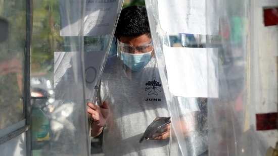 A man wearing a face mask and a face shield as protection against Covid-19 enters a disinfection booth at a community quarantine checkpoint, in Pasay, Metro Manila, Philippines. (Reuters file photo)
