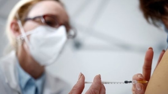 A nurse administers the Covid-19 vaccine.(Reuters)