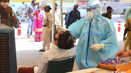 People being tested for Covid-19 during a random testing drive at Anand Vihar Bus Terminal, in New Delhi, on May 10. Delhi reported 13,287 new Covid-19 cases on May 12.(Raj K Raj / HT Photo)