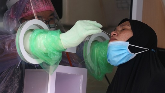 A hospital worker administers a swab test for Covid-19 in southern Thailand's Pattani province. (AFP) A hospital worker administers a swab test for Covid-19 in southern Thailand's Pattani province. (AFP)
