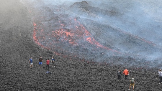 People watch as lava flows from Guatemala's Pacaya Volcano at the Cerro Chino hill in San Vicente Pacaya municipality, Guatemala. (AFP) People watch as lava flows from Guatemala's Pacaya Volcano at the Cerro Chino hill in San Vicente Pacaya municipality, Guatemala. (AFP)