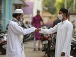 Men greet each other after offering prayers during Eid-al-Fitr festival, which marks the end of Islamic holy fasting month of Ramzan, outside their home during a Covid-19 induced lockdown, in Hyderabad on May 14. Amid a surge in Covid-19 cases, people in most parts of India offered namaz at their homes.(Noah Seelam / AFP)