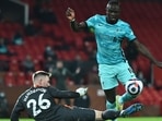 Manchester United's Dean Henderson in action with Liverpool's Sadio Mane 
