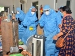 Goa chief minister Pramod Sawant (right), wearing a personal protective equipment suit, speaks to Covid-19 patients at the Goa Medical College and Hospital.
