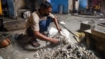 A worker collects unclaimed ashes of Covid-19 victims, at Nigambodh Ghat, in New Delhi.(Amal KS/HT PHOTO) A worker collects unclaimed ashes of Covid-19 victims, at Nigambodh Ghat, in New Delhi.(Amal KS/HT PHOTO)