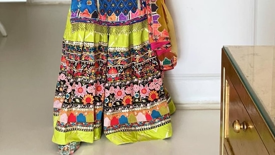 Gauahar's blue tunic was paired with a green garara with multiple floral laces and gota stitched onto it. The ensemble was completed with ochre coloured net dupatta and floral mojris.(Instagram)