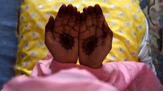 A woman offers prayer inside her home during Eid-al-Fitr, on May 14.(Prakash Mathema / AFP)
